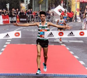 man running on black asphalt road